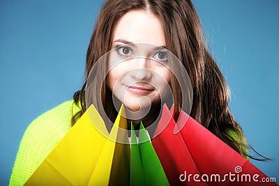 Young woman with paper multi coloured shopping bag