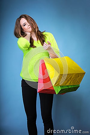 Young woman with paper multi coloured shopping bag