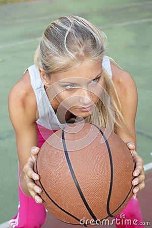 Young woman playing basketball