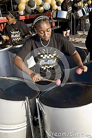 A young woman playing steel drums