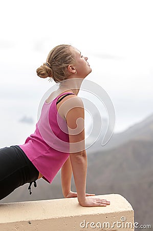 Young woman practicing yoga on the nature