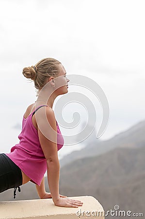 Young woman practicing yoga on the nature