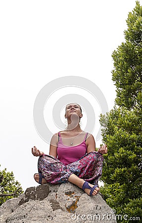 Young woman practicing yoga on the nature
