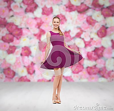Young woman in purple dress and high heels