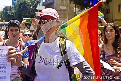 Young woman with rainbow flag at Pride Parade TA