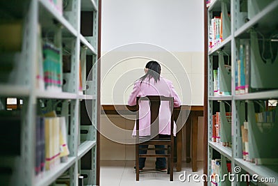 Young woman reading in library