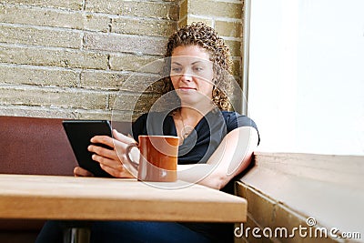 Young woman reading from tablet