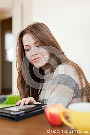 Young woman reads e-reader