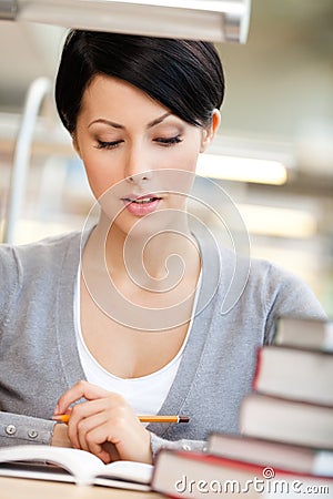 Young woman reads at the reading hall