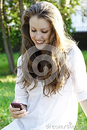 Young woman reads sms