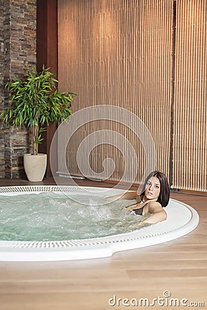 Young woman relaxing in the hot tub