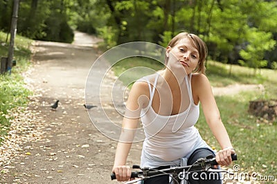 Young woman riding with bike