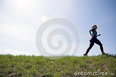Young woman running outdoors, silhouette