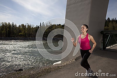 Young Woman Running Beside River