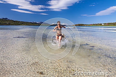 Young woman running on sea beach