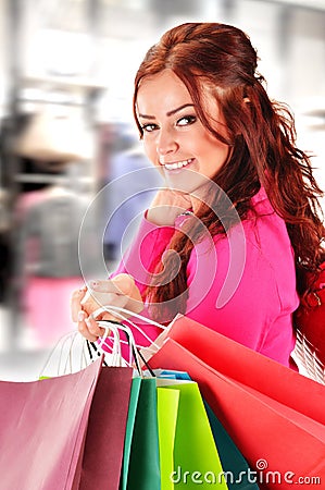 Young woman with shopping bags in the store