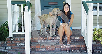 Young woman sitting on porch with her dog
