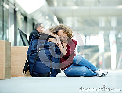 Young woman sleeping at airport