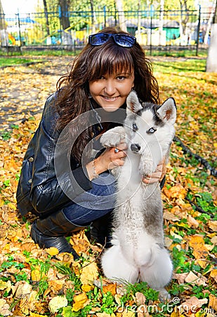 Young woman and small dog siberian husky