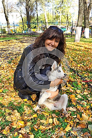Young woman and small dog siberian husky