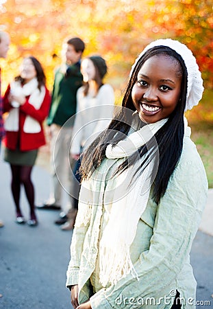 Young woman smiling with friends in the background