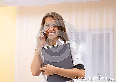 Young woman speak by phone with financial papers