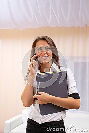 Young woman speak by phone with financial papers