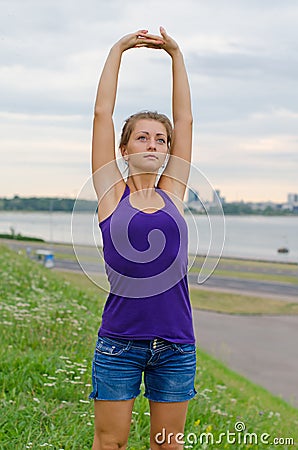 Young woman stretches.