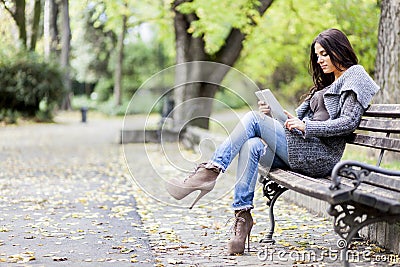 Young woman with tablet on the bench