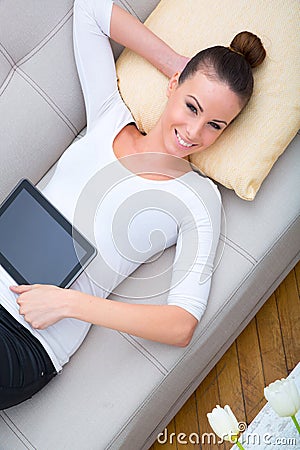 Young woman with a Tablet PC on the Sofa