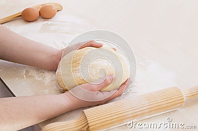 Taking the dough with both hands