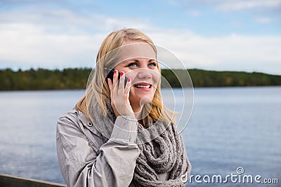 Young woman talking on the phone and smiling