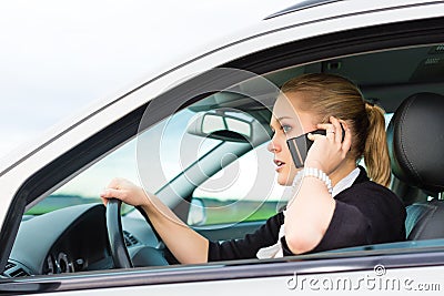 Young woman with telephone in car