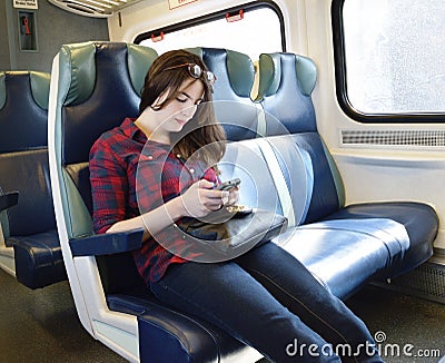 Young Woman Texting on Train