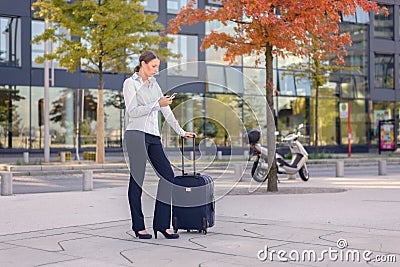 Young woman traveler texting on a mobile phone