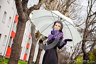 Young woman with umbrella looking for rain
