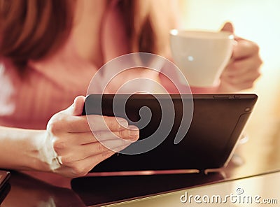 Young woman using tablet computer in cafe