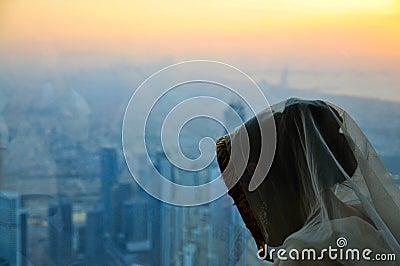 Young woman in veil, and view from Burj Khalifa