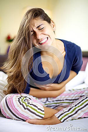 Young woman with very strong stomach ache