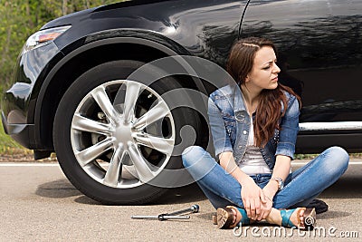 Young woman waiting for roadside assistance