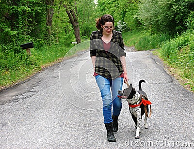 Young Woman Walking her dog for exercise