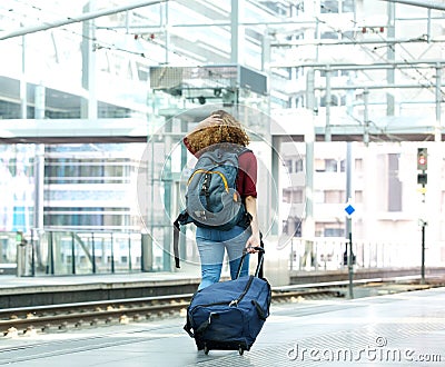 Young woman walking with luggage