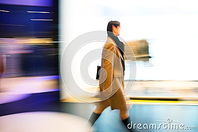 Young woman walking past shop front window