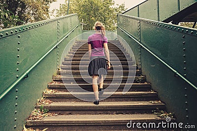 Young woman walking up stairs