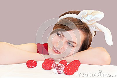 Young woman wearing easter bunny ears.