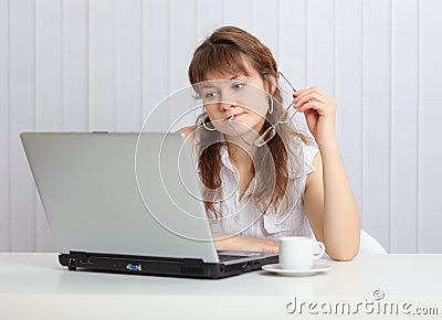 Young woman working with laptop computer at table