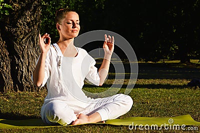 Young woman during yoga meditation in the park
