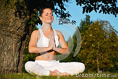 Young woman during yoga meditation in the park