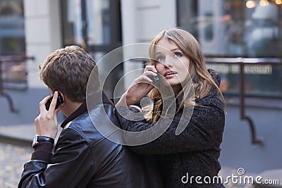 Young women and men talking on mobile phone