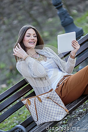 Young women in the park with tablet